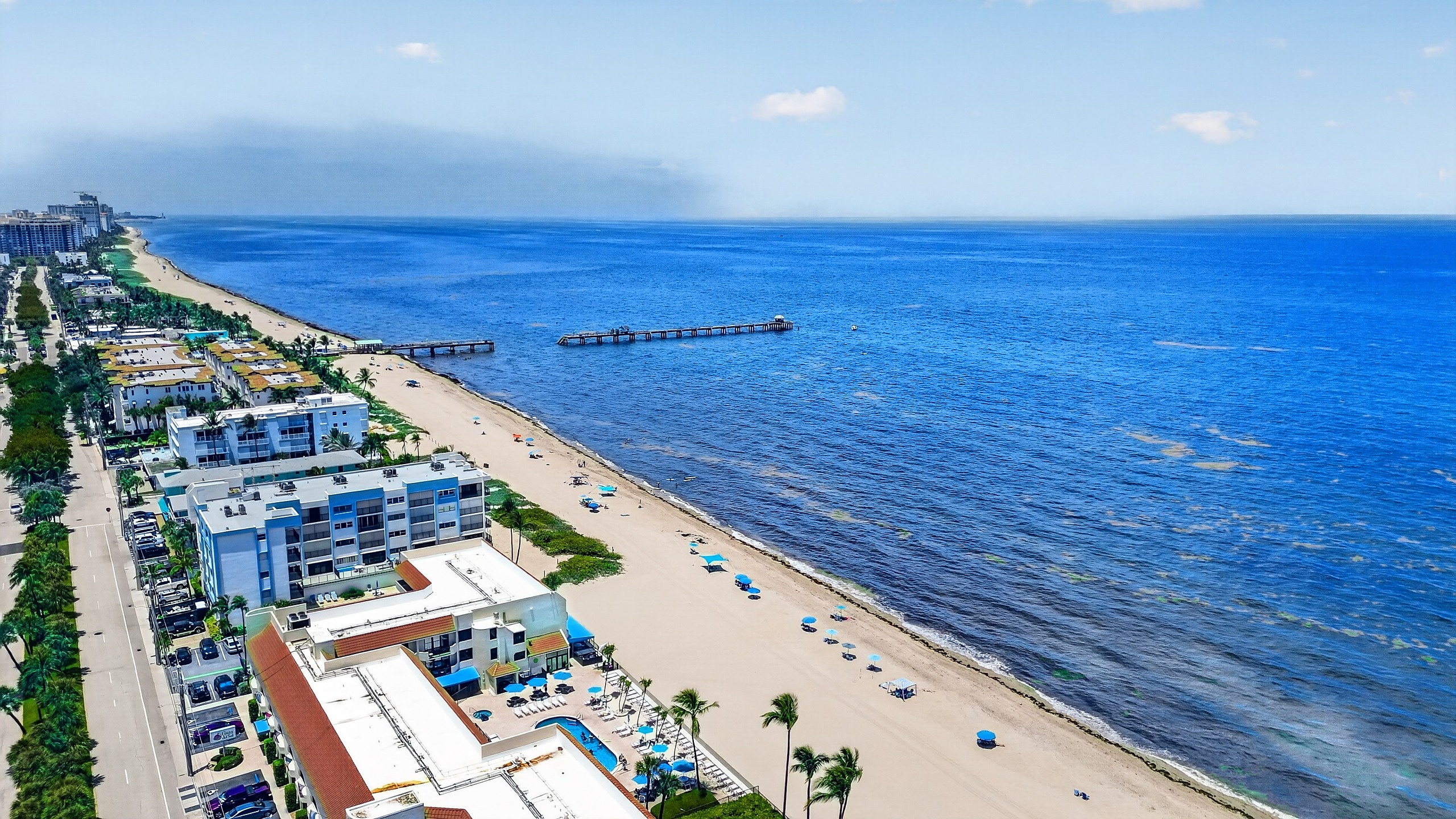 Aerial of the Lauderdale-By-The-Sea shoreline, pier, and sand